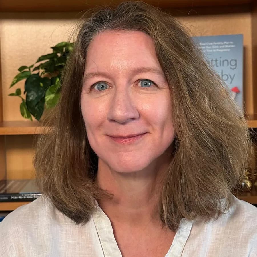 Angela Thyer in front of a bookcase